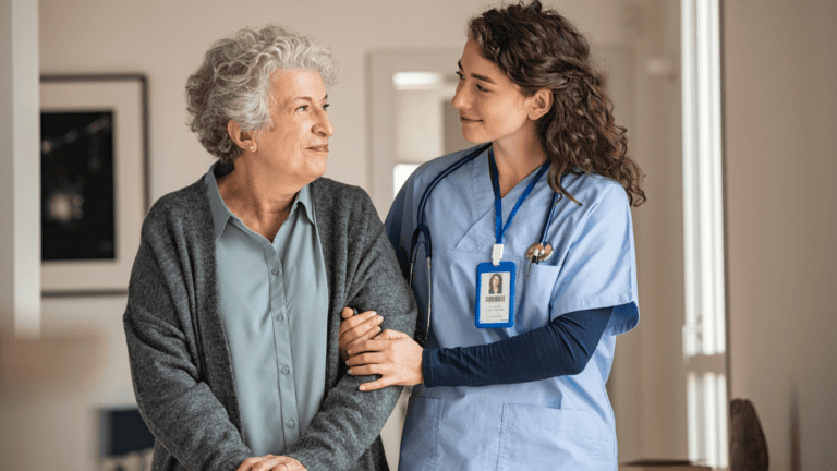 Healthcare worker assisting elder patient, CNA hero image