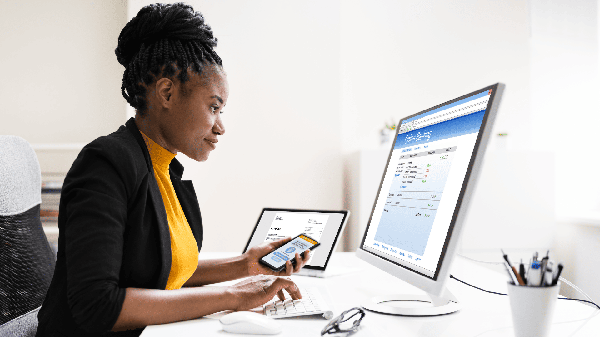 women at desk with computer performing bookkeeping duties