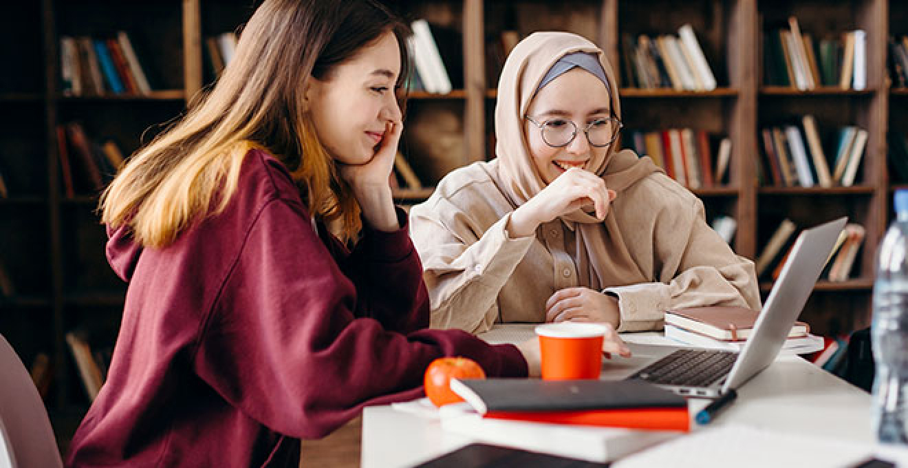 two female students looking at computer