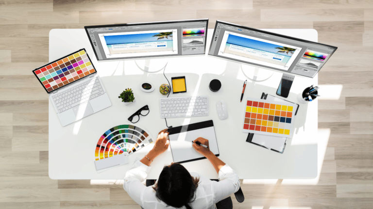 An aerial image of a graphic designer working at a computer