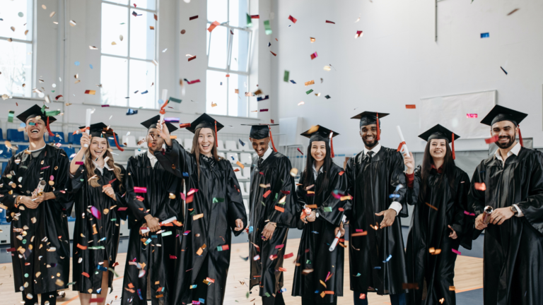 group of graduates with confetti falling