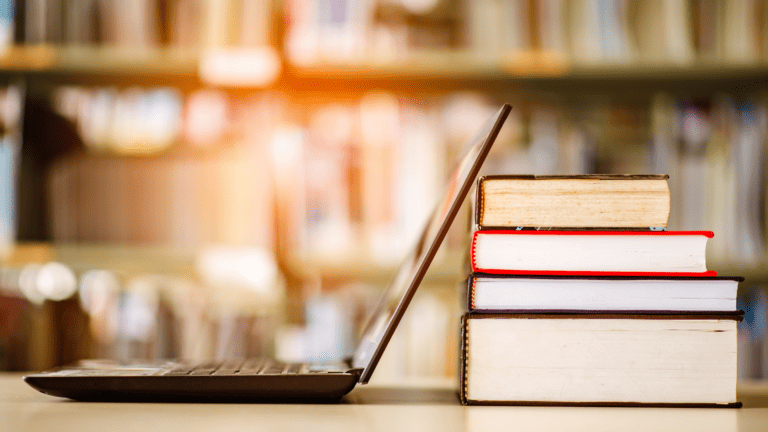 photo of computer and books