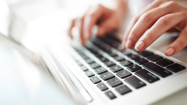 A person typing on a laptop