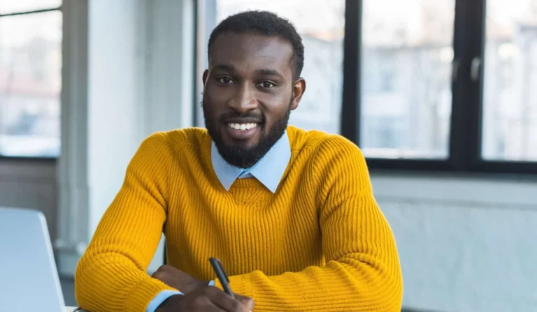 man smiling at desk