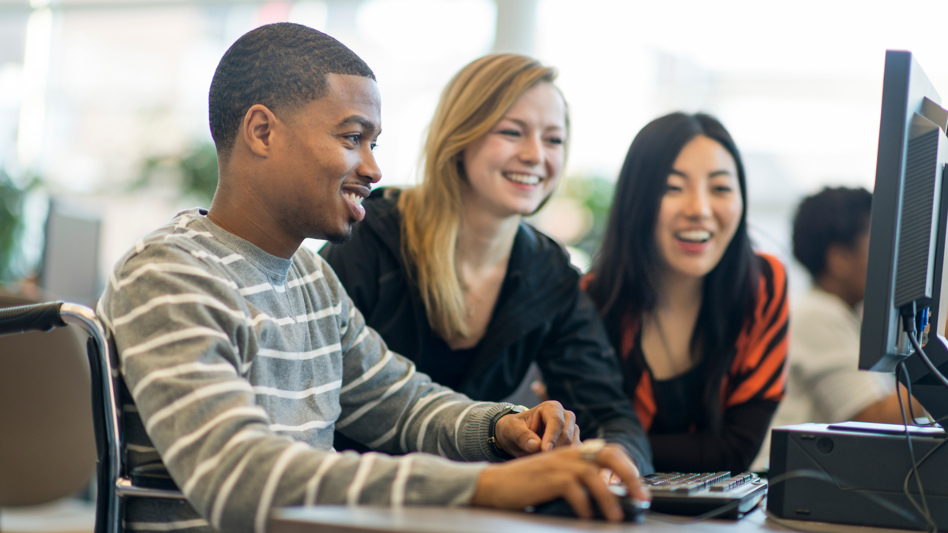 young students in front of computer